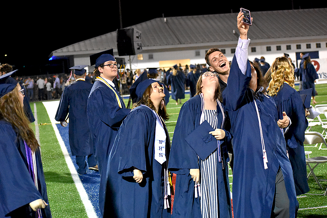 Friends take a selfie on graduation night.