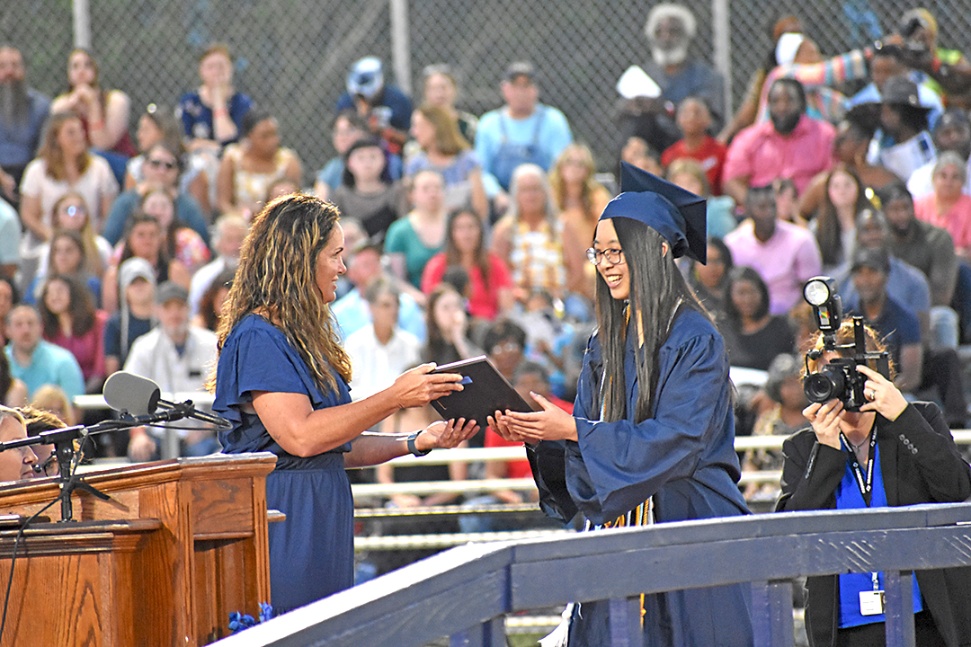 Salutatorian Brianna Ly receiving her diploma before her speech to the Class of 2023.