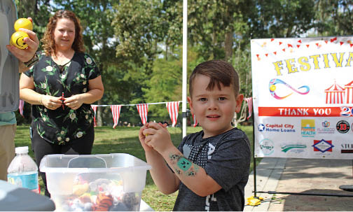 Saturday was one of the Festivals of Joy for special needs kids held quarterly at Wakulla Springs Lodge, organized by Mary Wallace, who created the non-profit Joy-ful Journeys to support the events. Here, Ethan Pache gets a prize from a ball drop event. (Photo by Linda Ann McDonald)